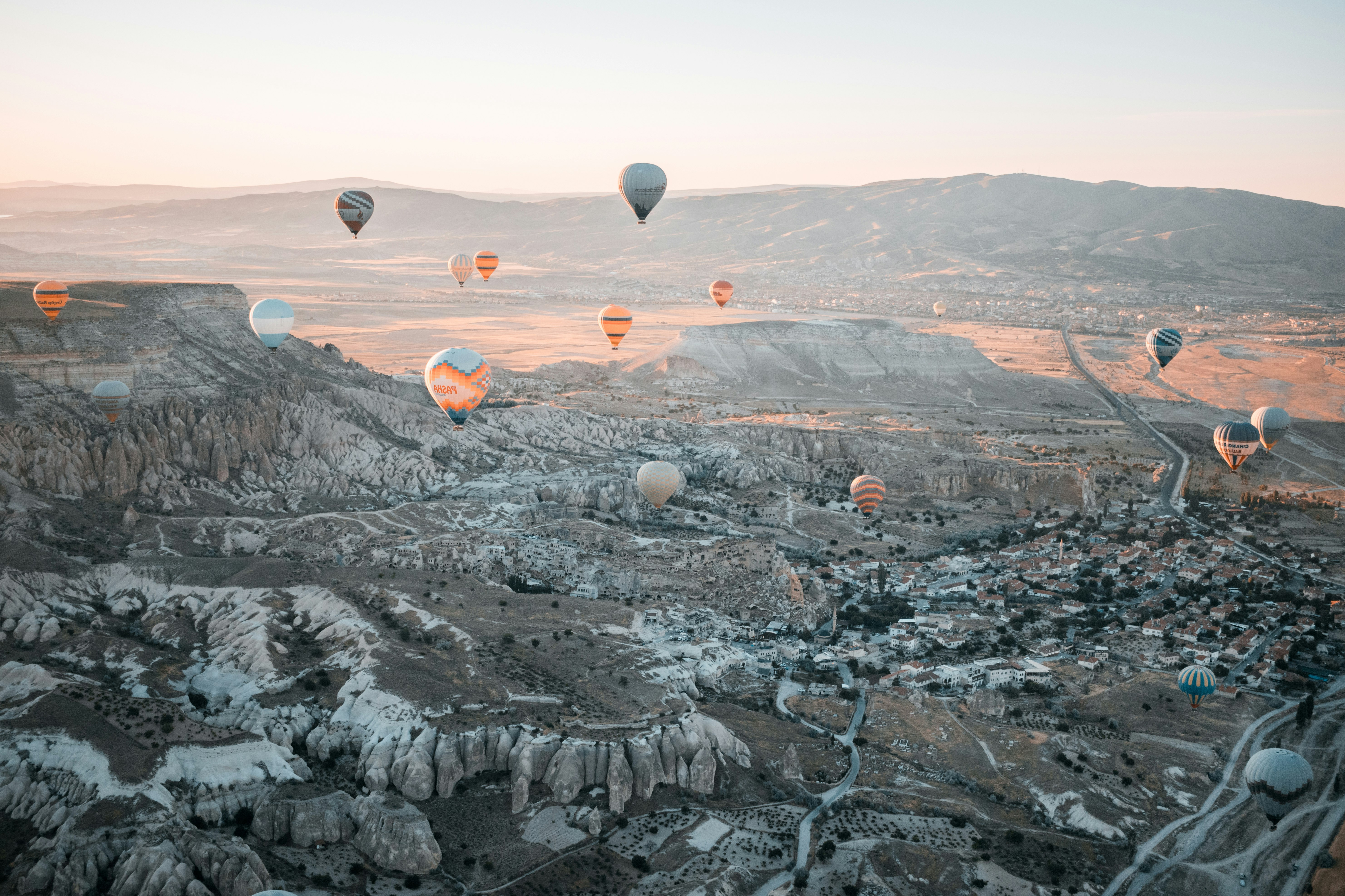 hot air balloons floating over the mountains